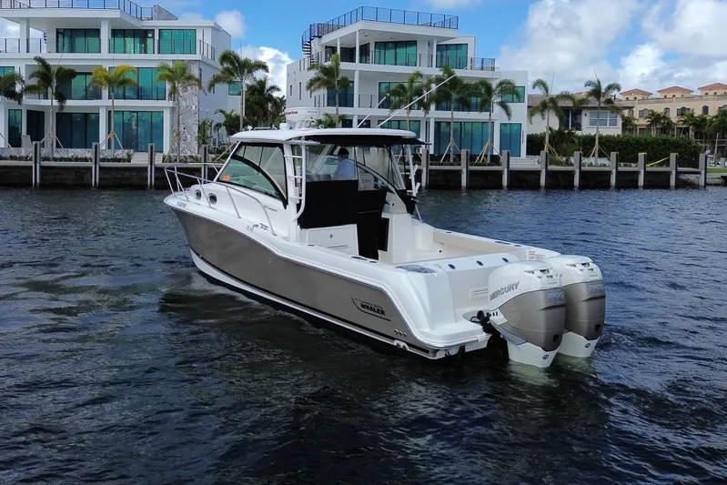  Yacht Photos Pics 2019 Boston Whaler 315 Conquest boat near modern waterfront villas.