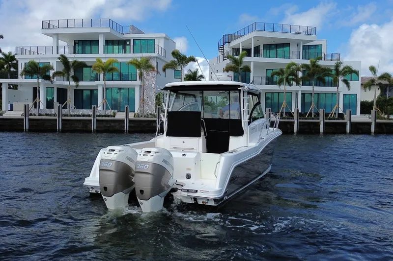  Yacht Photos Pics 2019 Boston Whaler 315 Conquest near modern waterfront villas.