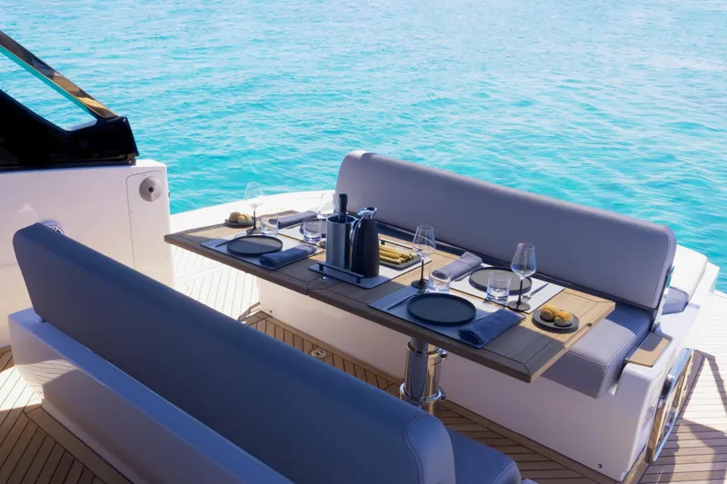  Yacht Photos Pics Luxury dining setup on 2026 FIM 440 Regina yacht, overlooking serene blue ocean.