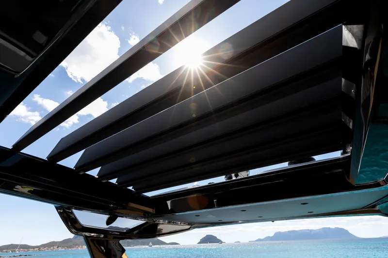  Yacht Photos Pics Sunlight through slatted roof of 2026 FIM 440 Regina yacht, ocean and mountains in background.