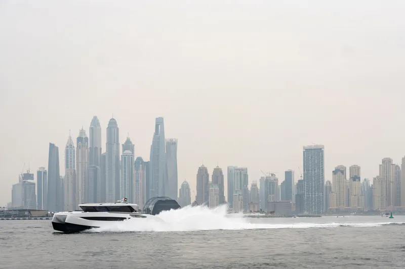  Yacht Photos Pics 2026 Sunreef Ultima 55 yacht cruising near a modern city skyline.