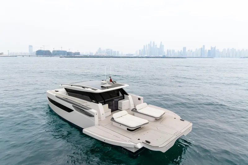  Yacht Photos Pics Luxurious 2026 Sunreef Ultima 55 yacht cruising near a modern city skyline.