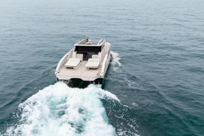  Yacht Photos Pics 2026 Sunreef Ultima 55 yacht cruising on open sea, rear view.