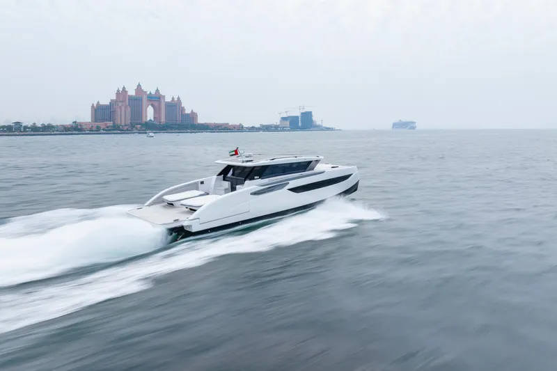  Yacht Photos Pics 2026 Sunreef Ultima 55 yacht cruising near iconic waterfront architecture.