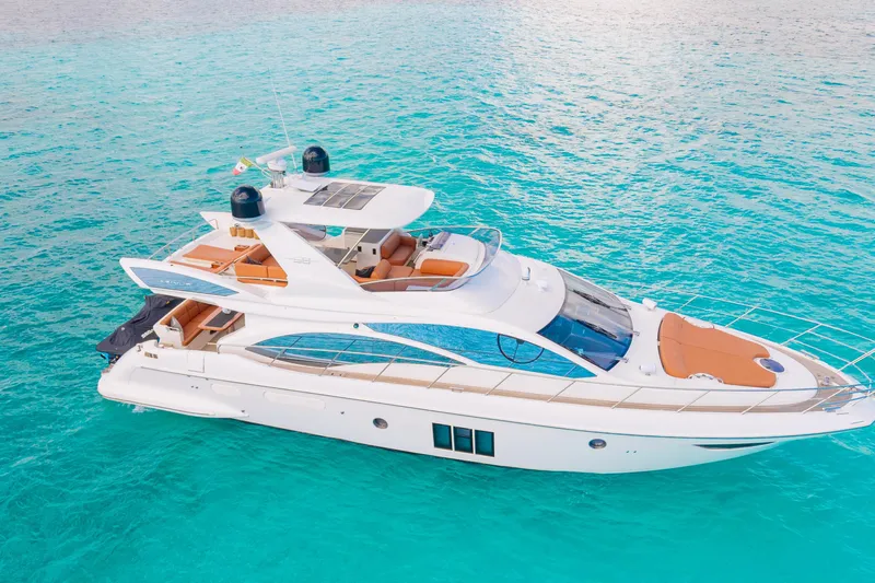 Golden Sun Yacht Photos Pics Luxurious 2011 Azimut 58 yacht cruising on clear turquoise waters.
