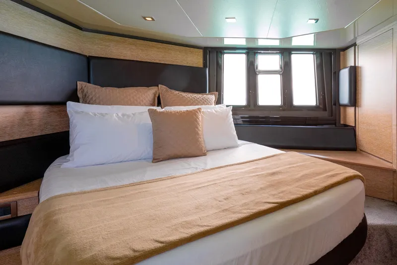 Golden Sun Yacht Photos Pics Luxurious bedroom interior of 2011 Azimut 58 yacht with elegant bedding and natural light.