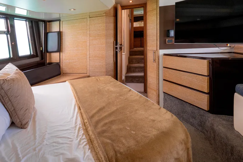 Golden Sun Yacht Photos Pics Luxurious bedroom interior of 2011 Azimut 58 yacht with modern furnishings and large windows.