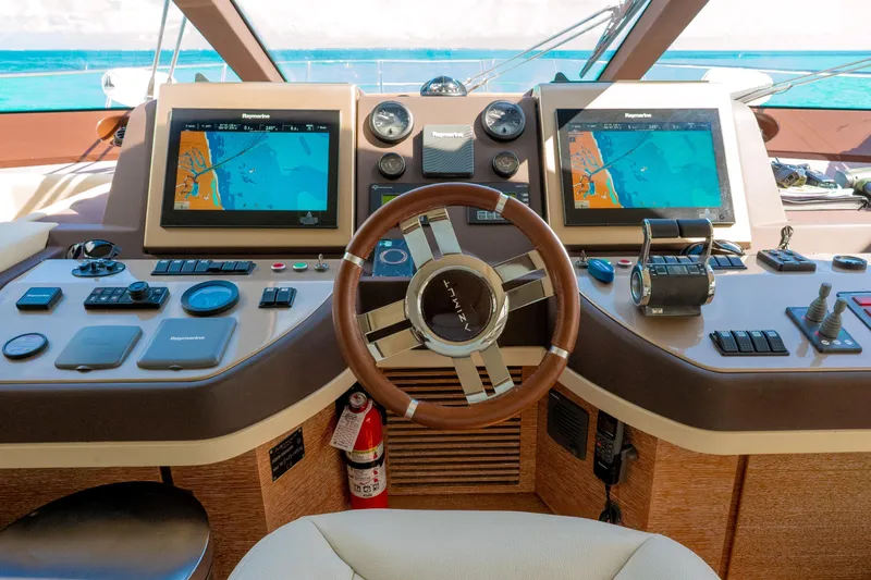 Golden Sun Yacht Photos Pics Cockpit of 2011 Azimut 58 yacht with navigation screens and steering wheel.
