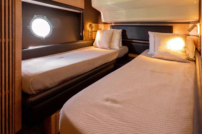 Golden Sun Yacht Photos Pics Interior of 2011 Azimut 58 yacht with twin beds and porthole window.