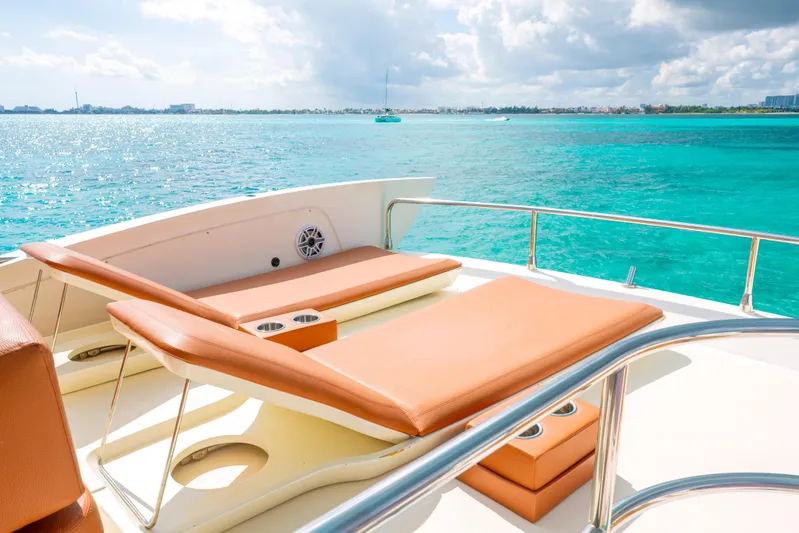 Golden Sun Yacht Photos Pics Luxurious 2011 Azimut 58 yacht deck with sun loungers overlooking turquoise ocean waters.