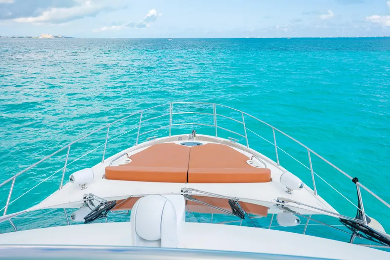 Golden Sun Yacht Photos Pics Bow view of 2011 Azimut 58 yacht on turquoise ocean waters.