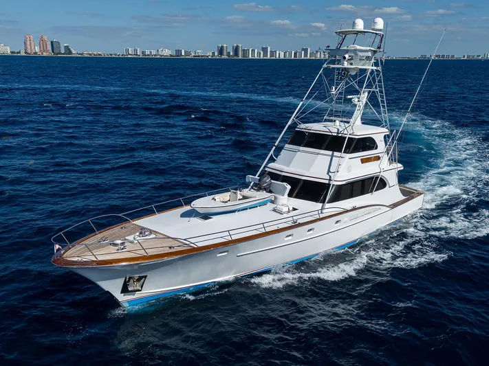 Thanks Buds Yacht Photos Pics 1985 Feadship Yacht Fisherman cruising on open sea with city skyline in background.