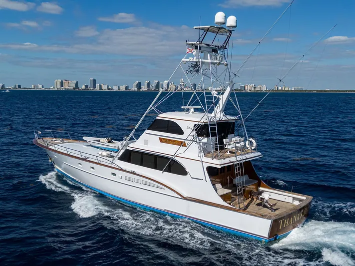 Thanks Buds Yacht Photos Pics 1985 Feadship Yacht Fisherman cruising on open water with city skyline in background.