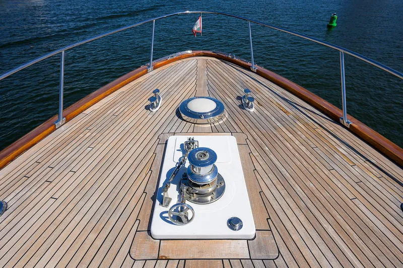 Thanks Buds Yacht Photos Pics Bow of 1985 Feadship Yacht Fisherman with teak deck and winch, on calm water.