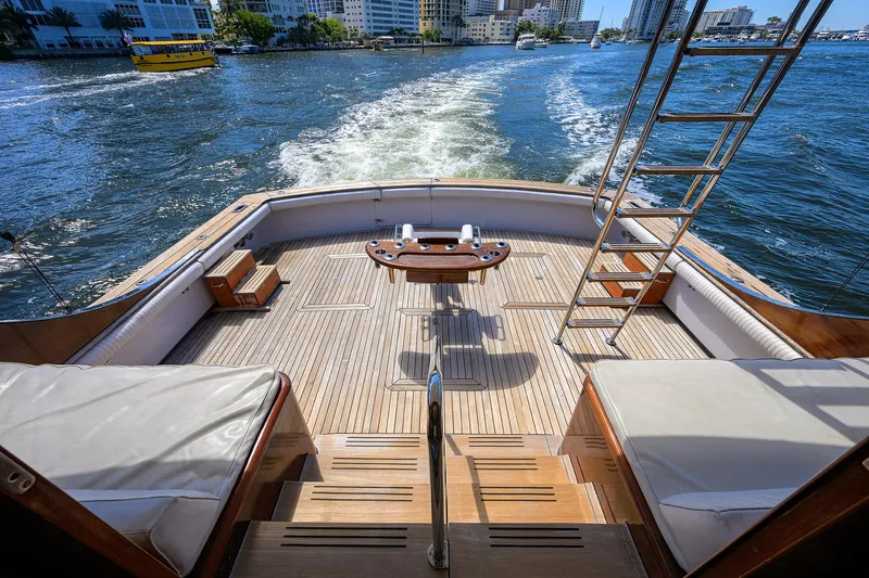 Thanks Buds Yacht Photos Pics 1985 Feadship Yacht Fisherman deck with ocean view, featuring wooden flooring and seating.