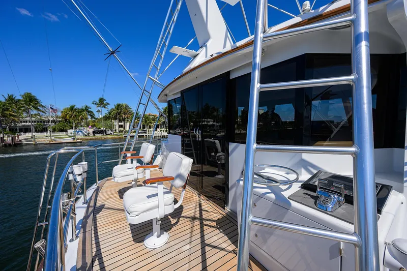 Thanks Buds Yacht Photos Pics Luxurious 1985 Feadship Yacht Fisherman deck with seating, ladder, and ocean view.