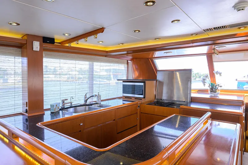 Thanks Buds Yacht Photos Pics Luxurious kitchen interior of 1985 Feadship Yacht Fisherman with modern appliances and sleek design.