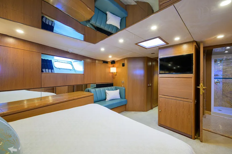 Thanks Buds Yacht Photos Pics Luxurious 1985 Feadship Yacht Fisherman cabin with wood paneling, bed, sofa, and TV.