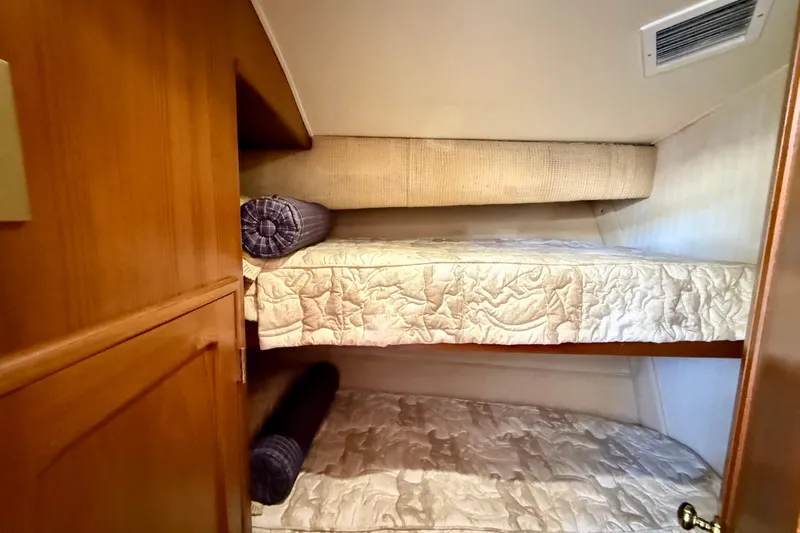 Easy Goin' Yacht Photos Pics 1996 Egg Harbor 35 Sport Fisherman cabin with cozy bunk beds and wooden cabinetry.