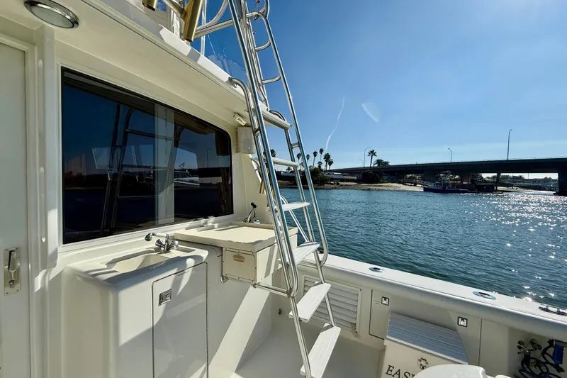 Easy Goin' Yacht Photos Pics 1996 Egg Harbor 35 Sport Fisherman boat with ladder, sink, and scenic waterfront view.