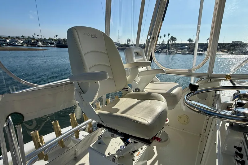 Easy Goin' Yacht Photos Pics 1996 Egg Harbor 35 Sport Fisherman helm with white captain chairs and waterfront view.