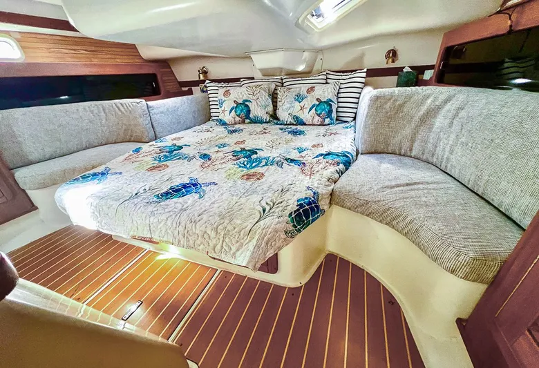 Moondust Yacht Photos Pics Cozy cabin interior of 1997 Catalina 380 yacht with nautical-themed bedding.