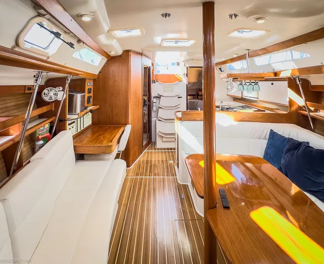 Moondust Yacht Photos Pics Interior of a 1997 Catalina 380 yacht, featuring wood finishes and white upholstery.