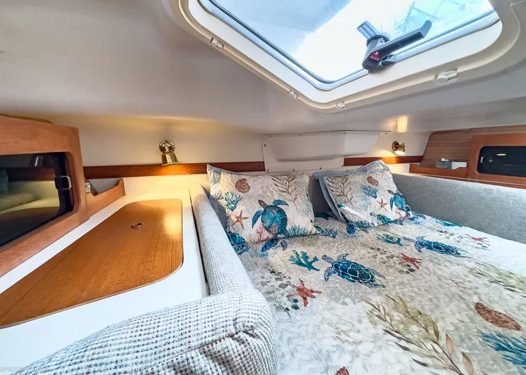 Moondust Yacht Photos Pics Interior of a Catalina 380 yacht, cozy bedroom with skylight.