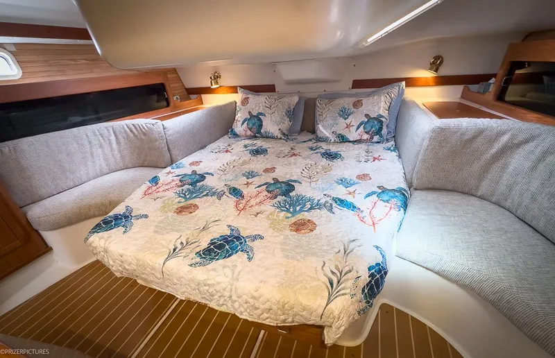 Moondust Yacht Photos Pics Interior of a 1997 Catalina 380 yacht with nautical-themed bedding.