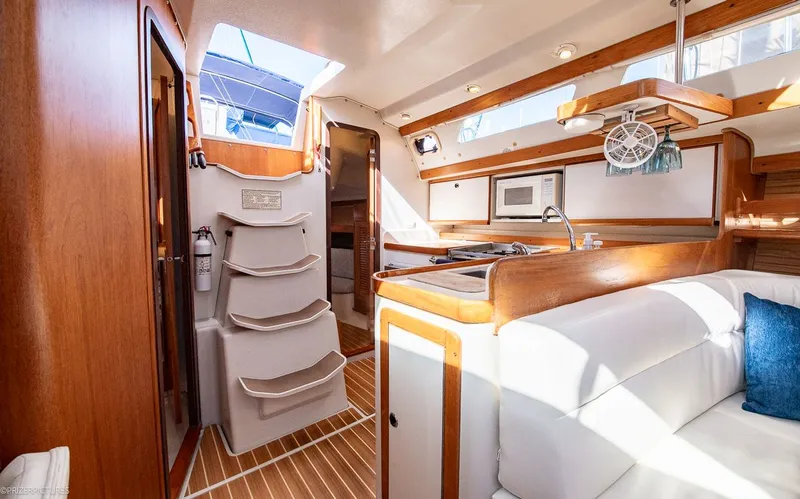 Moondust Yacht Photos Pics Interior of a 1997 Catalina 380 yacht with kitchen and seating area.