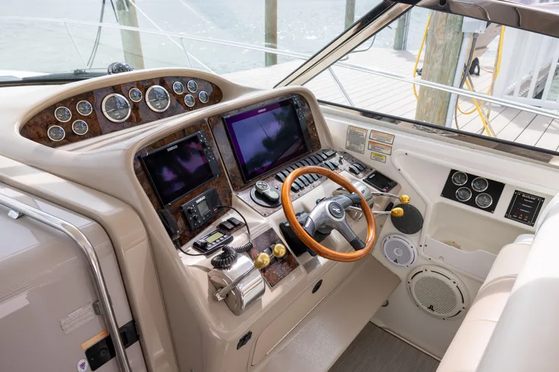 Yacht Photos Pics Cockpit of 2000 Sea Ray 370 Express Cruiser with advanced navigation controls and wooden steering wheel.