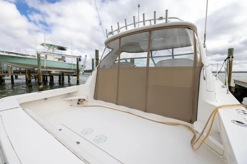  Yacht Photos Pics 2000 Sea Ray 370 Express Cruiser docked, showcasing spacious deck and covered cockpit area.