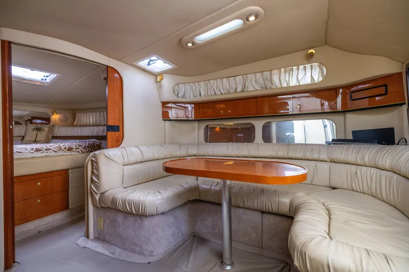  Yacht Photos Pics Luxurious interior of 2000 Sea Ray 370 Express Cruiser with plush seating and wooden accents.
