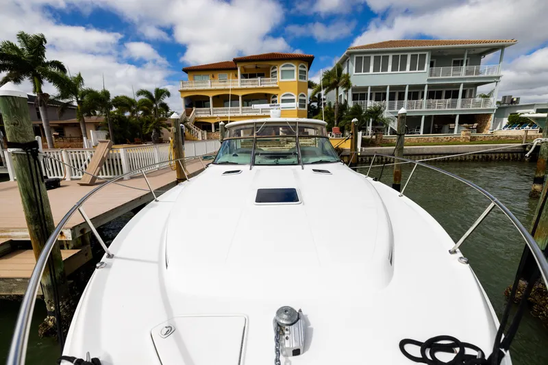  Yacht Photos Pics 2000 Sea Ray 370 Express Cruiser docked near waterfront homes under a blue sky.