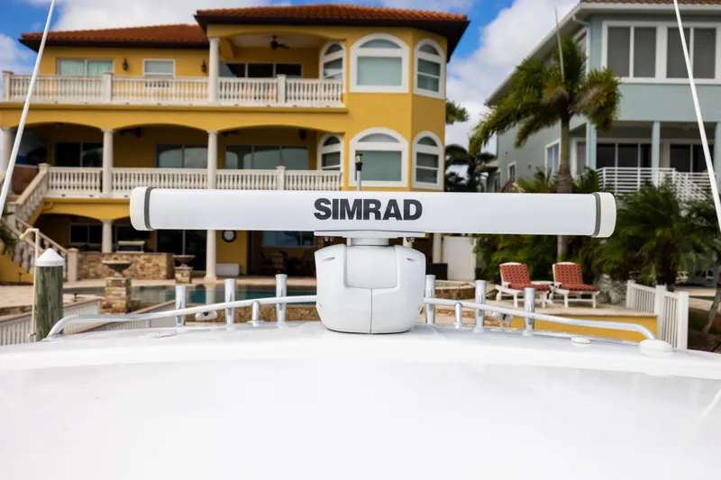  Yacht Photos Pics Radar on 2000 Sea Ray 370 Express Cruiser, with waterfront homes in the background.