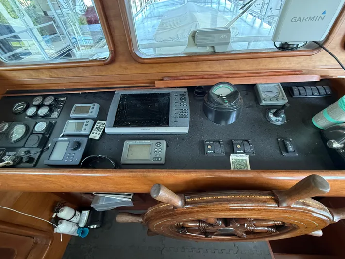 Passage Yacht Photos Pics Cockpit of a 2009 Custom Dutch Canal Barge with navigation instruments and wooden steering wheel.