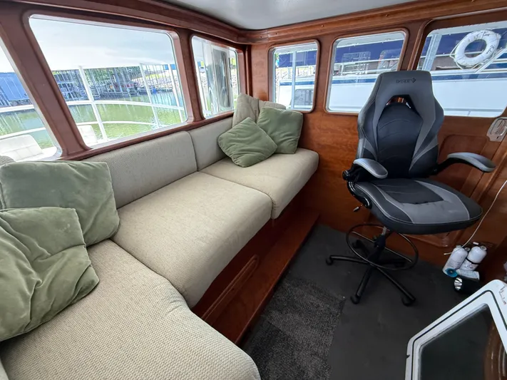 Passage Yacht Photos Pics Interior of a 2009 Custom Dutch Canal Barge with cozy seating and a swivel chair.