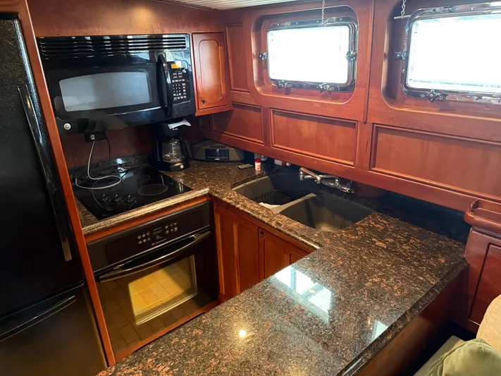 Passage Yacht Photos Pics Luxurious kitchen interior of a 2009 custom Dutch canal barge with granite countertops.