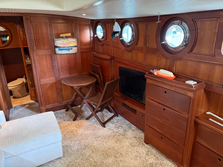 Passage Yacht Photos Pics Luxurious interior of a 2009 custom Dutch canal barge with wood paneling and porthole windows.