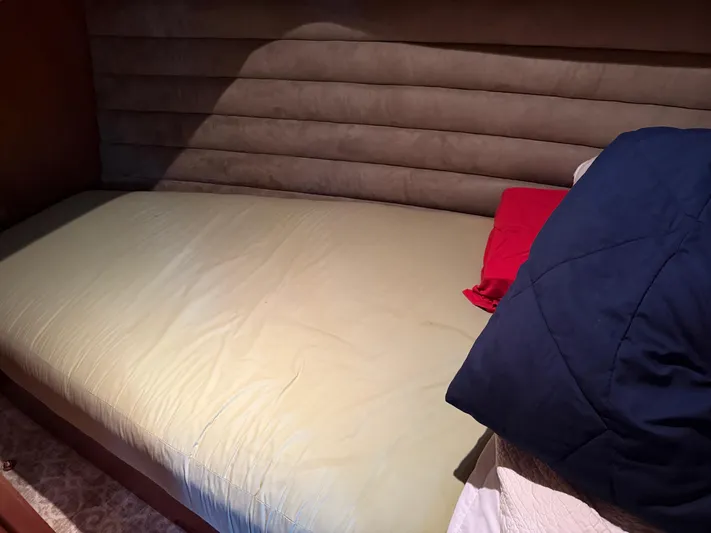 Passage Yacht Photos Pics Single bed with red and blue pillows on a Dutch Canal Barge, 2009 model.