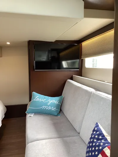  Yacht Photos Pics Interior of 2018 Regal 42 Fly yacht with sofa, TV, and decorative pillows.