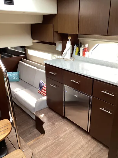  Yacht Photos Pics Luxurious interior of 2018 Regal 42 Fly yacht with modern kitchen and cozy seating area.