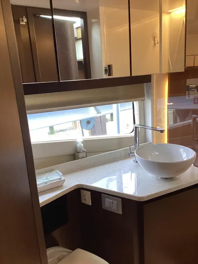  Yacht Photos Pics Luxurious bathroom interior of 2018 Regal 42 Fly yacht with modern fixtures.