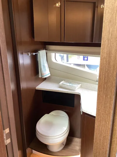  Yacht Photos Pics 2018 Regal 42 Fly yacht bathroom with modern fixtures and wood cabinetry.