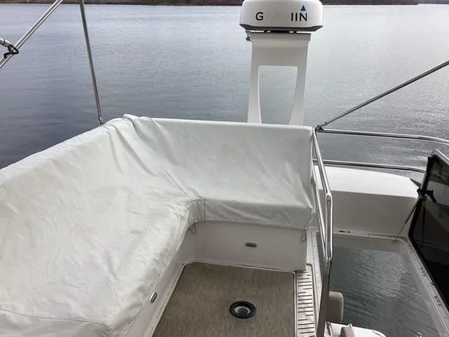  Yacht Photos Pics Regal 42 Fly 2018 yacht deck with covered seating area on calm water.
