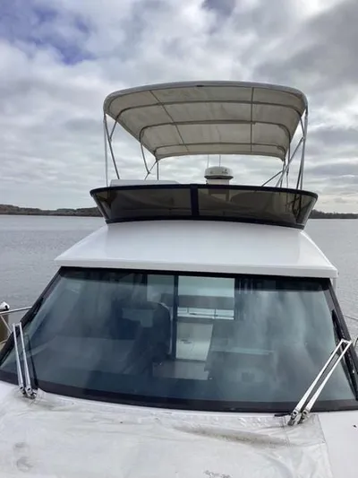  Yacht Photos Pics 2018 Regal 42 Fly yacht with flybridge, docked on a cloudy day.