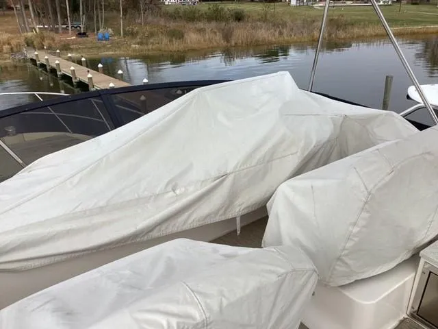  Yacht Photos Pics Covered 2018 Regal 42 Fly boat docked by a serene waterfront.