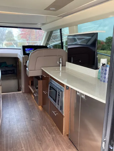  Yacht Photos Pics Interior of 2018 Regal 42 Fly yacht with modern kitchen and navigation area.