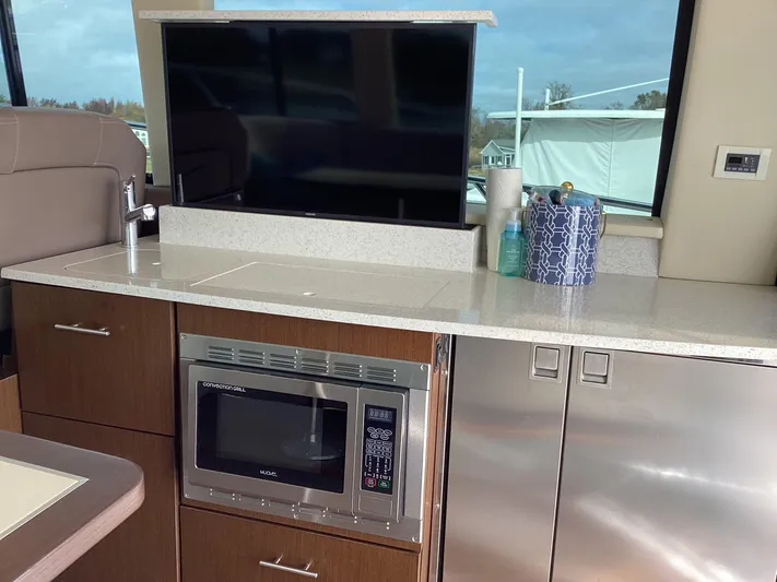  Yacht Photos Pics Modern kitchen area in 2018 Regal 42 Fly yacht with microwave and TV.