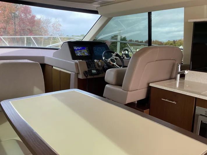  Yacht Photos Pics Interior of 2018 Regal 42 Fly yacht with modern helm and seating area.